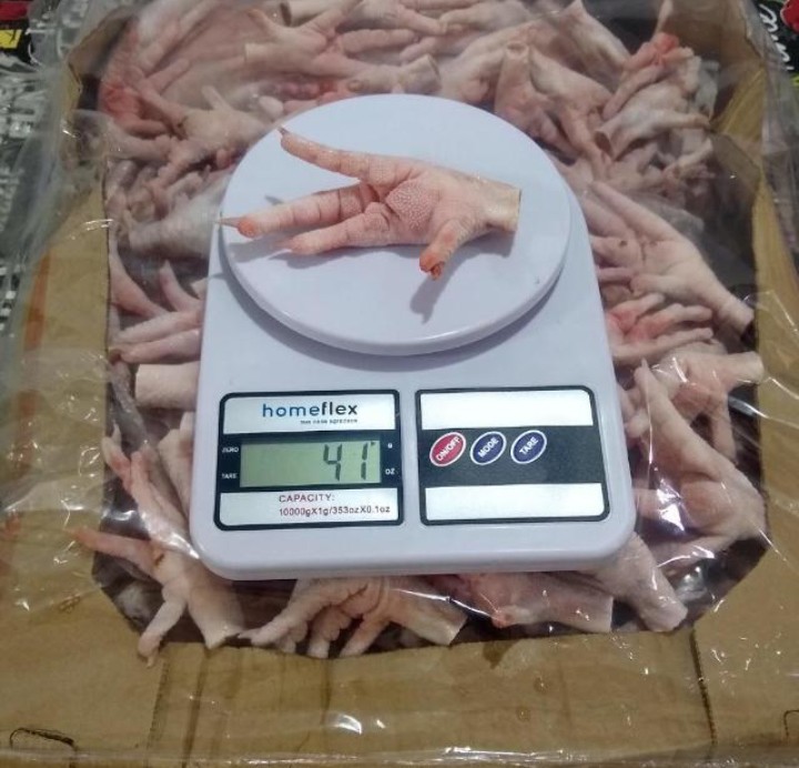 Grade A frozen chicken paw on scale — 41g per piece